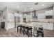 Modern kitchen featuring granite countertops, stainless steel appliances, and a large island with seating at 20595 W Pasadena Ave, Buckeye, AZ 85396