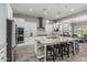 Contemporary kitchen featuring stainless steel appliances, large island with breakfast bar, and modern lighting at 20595 W Pasadena Ave, Buckeye, AZ 85396