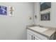 Laundry room sink and counter with classic vintage posters, next to a window at 20595 W Pasadena Ave, Buckeye, AZ 85396