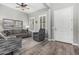 Well-lit living room features shuttered windows and a decorative cross at 20595 W Pasadena Ave, Buckeye, AZ 85396