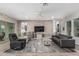 Inviting living room features a brick accent wall and modern furnishings at 20595 W Pasadena Ave, Buckeye, AZ 85396