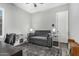 Neutral living room with a gray sofa, patterned rug, and white cube storage units at 20595 W Pasadena Ave, Buckeye, AZ 85396