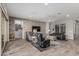 Cozy living room featuring comfortable seating, a stone accent wall, and abundant natural light at 20595 W Pasadena Ave, Buckeye, AZ 85396