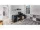 Home office featuring a dark desk, rolling chair, and a stylish area rug at 20595 W Pasadena Ave, Buckeye, AZ 85396