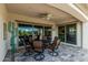Covered patio features dining area and outdoor access from multiple rooms of the house at 20595 W Pasadena Ave, Buckeye, AZ 85396