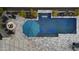 Aerial view of a backyard pool area, with a fire pit, lounge chairs, waterfall feature, and desert landscaping at 20595 W Pasadena Ave, Buckeye, AZ 85396