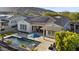 Stunning home featuring a private pool, outdoor seating, firepit, covered patio, and solar panels on the roof at 20595 W Pasadena Ave, Buckeye, AZ 85396