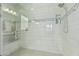 Modern tiled shower with glass door, rain shower head, and built-in niche for toiletries at 20595 W Pasadena Ave, Buckeye, AZ 85396