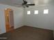 Spacious bedroom features carpeted floors, ceiling fan, and three above ground windows at 22632 W Solano Dr, Buckeye, AZ 85326