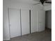 Bedroom features a large closet with sliding doors, carpeted flooring and ceiling fan at 22632 W Solano Dr, Buckeye, AZ 85326