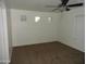 Bedroom with plush carpet, ceiling fan, and three above ground windows at 22632 W Solano Dr, Buckeye, AZ 85326