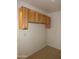 Closet features natural wood storage cabinets with space for hanging clothes at 22632 W Solano Dr, Buckeye, AZ 85326