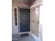 The front door and adjacent window compliment the security screen door at 22632 W Solano Dr, Buckeye, AZ 85326