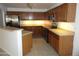 Well-lit kitchen featuring stainless steel appliances and wood cabinets at 22632 W Solano Dr, Buckeye, AZ 85326