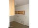 Laundry room featuring tile floors, wood cabinets and access to the exterior at 22632 W Solano Dr, Buckeye, AZ 85326