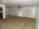 Spacious living room with neutral carpet, light walls, and a ceiling fan at 22632 W Solano Dr, Buckeye, AZ 85326