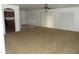 Open-concept living room features a ceiling fan and a sliding glass door at 22632 W Solano Dr, Buckeye, AZ 85326