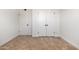 An empty bedroom featuring carpet floors, white walls and doors and white horizontal molding at 2342 N 40Th Ave, Phoenix, AZ 85009