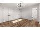 This bedroom features wood-look floors, white walls, and access to the ensuite bathroom at 2342 N 40Th Ave, Phoenix, AZ 85009