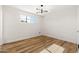 Bright bedroom with wood-look floors, white plank walls, and a modern light fixture at 2342 N 40Th Ave, Phoenix, AZ 85009
