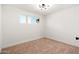 Cozy bedroom with carpet flooring, a window overlooking the yard and crisp white walls at 2342 N 40Th Ave, Phoenix, AZ 85009