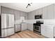 Updated kitchen showcases stainless steel appliances, grey cabinets and sleek white countertops at 2342 N 40Th Ave, Phoenix, AZ 85009