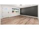 Stylish living room featuring modern decor, wood-look flooring, and a contrasting accent wall at 2342 N 40Th Ave, Phoenix, AZ 85009