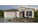 Charming single-story home showcasing stucco siding, a two-car garage, and low-maintenance landscaping at 25252 N 169Th Dr, Surprise, AZ 85387