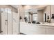 Modern bathroom with a glass shower, double sink vanity, and a large mirror at 25424 N 176Th Ave, Surprise, AZ 85387