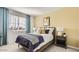 Bright bedroom with a window, light yellow walls, and modern decor at 25424 N 176Th Ave, Surprise, AZ 85387