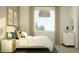 Comfortable bedroom with a large window, a bed, and a nightstand at 25424 N 176Th Ave, Surprise, AZ 85387