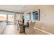 Elegant dining area with wood floors, large windows, stylish decor, and sliding door access to patio at 25424 N 176Th Ave, Surprise, AZ 85387