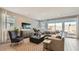 Inviting living room with modern furniture, large windows, and a seamless connection to the outdoors at 25424 N 176Th Ave, Surprise, AZ 85387
