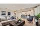 Spacious open-concept living area with a cozy seating area, adjacent dining space, and modern kitchen at 25424 N 176Th Ave, Surprise, AZ 85387