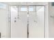Walk-in shower featuring clear glass doors and bright lighting at 25546 N 164Th Dr, Surprise, AZ 85387
