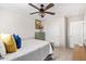 Cozy bedroom featuring a ceiling fan, vintage green cabinet, and matching headboard at 25546 N 164Th Dr, Surprise, AZ 85387