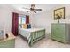 Cozy bedroom with a cottage bed frame, neutral walls, and coordinating furniture at 25546 N 164Th Dr, Surprise, AZ 85387