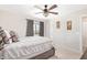 Bedroom featuring neutral color palette, dark drapes, and ceiling fan at 25546 N 164Th Dr, Surprise, AZ 85387