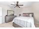 Bedroom featuring neutral color palette, dresser, and comfortable king bed at 25546 N 164Th Dr, Surprise, AZ 85387