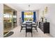 Cozy dining room with sliding glass doors to the backyard, stylish light fixture, telescope, and a dark colored buffet at 25546 N 164Th Dr, Surprise, AZ 85387