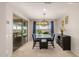 Elegant dining room with modern lighting, comfortable blue chairs and sliding door access to the backyard at 25546 N 164Th Dr, Surprise, AZ 85387