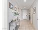 Inviting foyer featuring tile flooring, neutral walls with decorative art, and a console table with elegant decor at 25546 N 164Th Dr, Surprise, AZ 85387