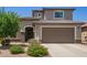 Charming two-story home features a well-manicured lawn, desert landscaping, and a spacious two car garage at 25546 N 164Th Dr, Surprise, AZ 85387