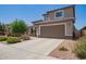 Charming two-story home features a well-manicured lawn, desert landscaping, and a spacious two car garage at 25546 N 164Th Dr, Surprise, AZ 85387
