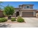 Charming two-story home features a well-manicured lawn, desert landscaping, and a spacious two car garage at 25546 N 164Th Dr, Surprise, AZ 85387