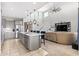 Open concept kitchen boasts a breakfast bar, stainless appliances, and adjacent living area at 25546 N 164Th Dr, Surprise, AZ 85387