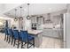 Beautiful kitchen features a large island with seating, stylish pendant lighting, and modern stainless steel appliances at 25546 N 164Th Dr, Surprise, AZ 85387