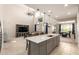 Bright, open-concept living area with high ceilings, modern kitchen island and neutral tones at 25546 N 164Th Dr, Surprise, AZ 85387