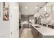 Bright kitchen with stainless steel appliances, a large island, pendant lights, and gray cabinets at 25546 N 164Th Dr, Surprise, AZ 85387