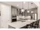 Charming kitchen featuring stainless steel appliances, gray cabinets, a backsplash and pendant lighting at 25546 N 164Th Dr, Surprise, AZ 85387